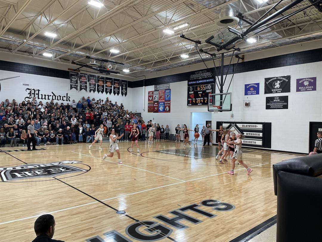 Tatum Backemeyer (right) of Elmwood-Murdock passes to Ella Zierott in the fourth quarter Friday, Feb. 24 in the D1-5 district chahmpionship against Sterling. The Knights beat the Jets 54-29.