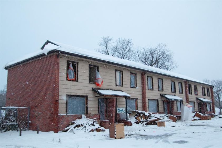 Snow falls on an abandoned apartment building that previously made up part of the Spencer Homes public housing development.