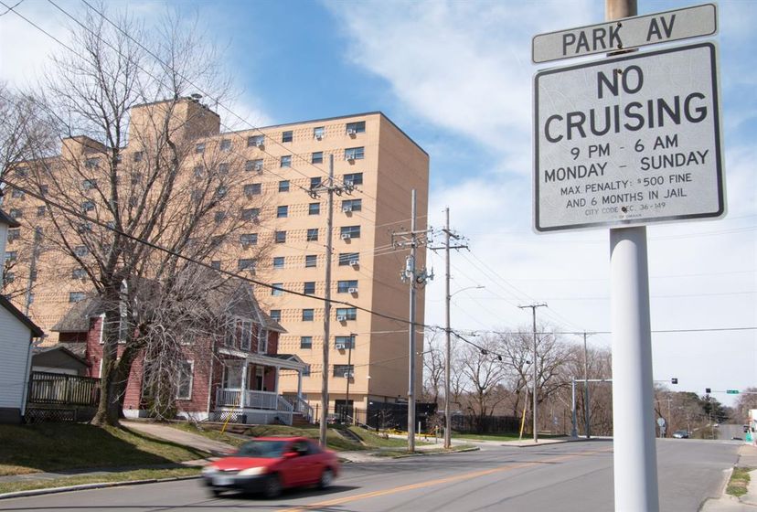A car zooms by a “No Cruising” sign on Woolworth Avenue in Omaha. Police haven’t issued a citation for cruising in more than a decade. The city isn’t replacing signs when they’re removed due to age.