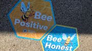 Cheerful bee sayings landscape Auburn sidewalks